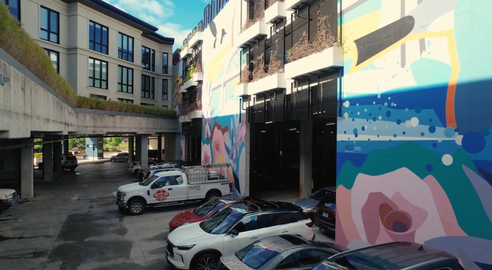 an alley with cars in front of a building