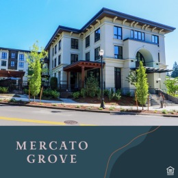 a white building with lush landscaping