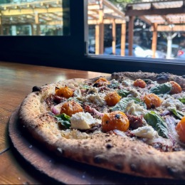 a plate of pizza near a window